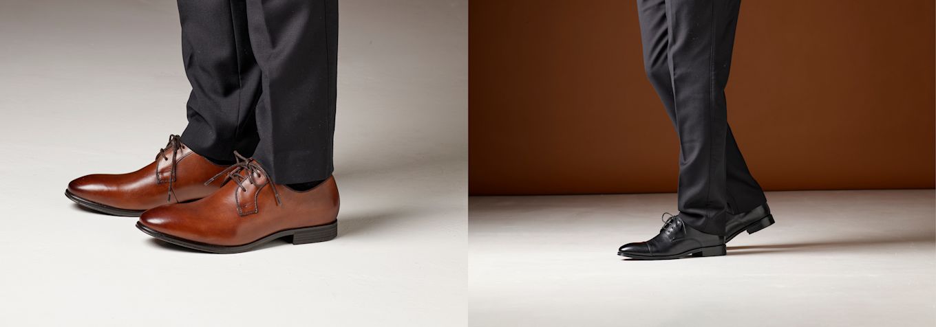 Elegante forretningssko i brunt og svart lær, vist med mørke dressbukser. Klassisk design med snøring og polert overflate.