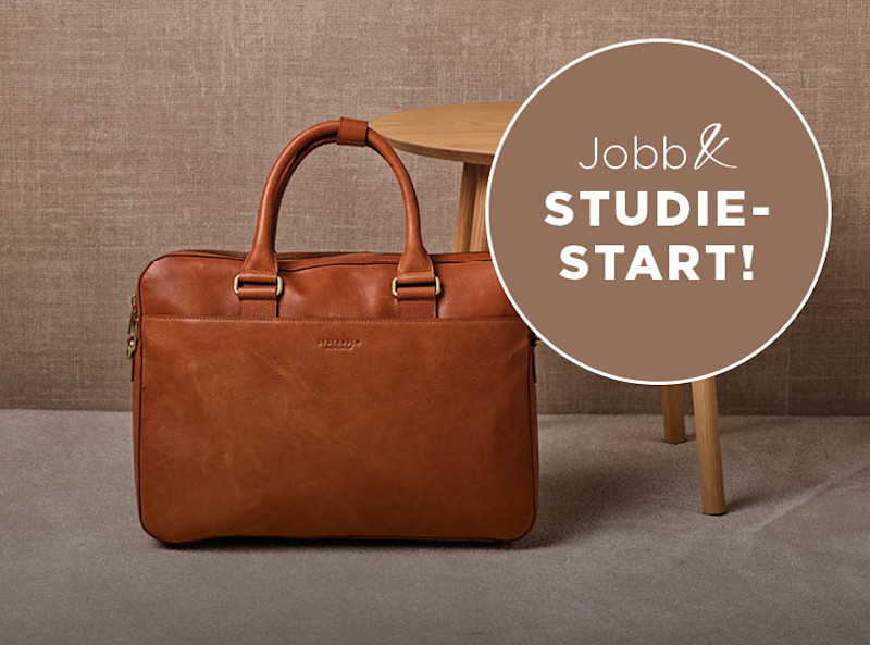 Cognacfarget skinnveske med håndtak, plassert foran et trebord. Tekst: Jobb & Studiestart!